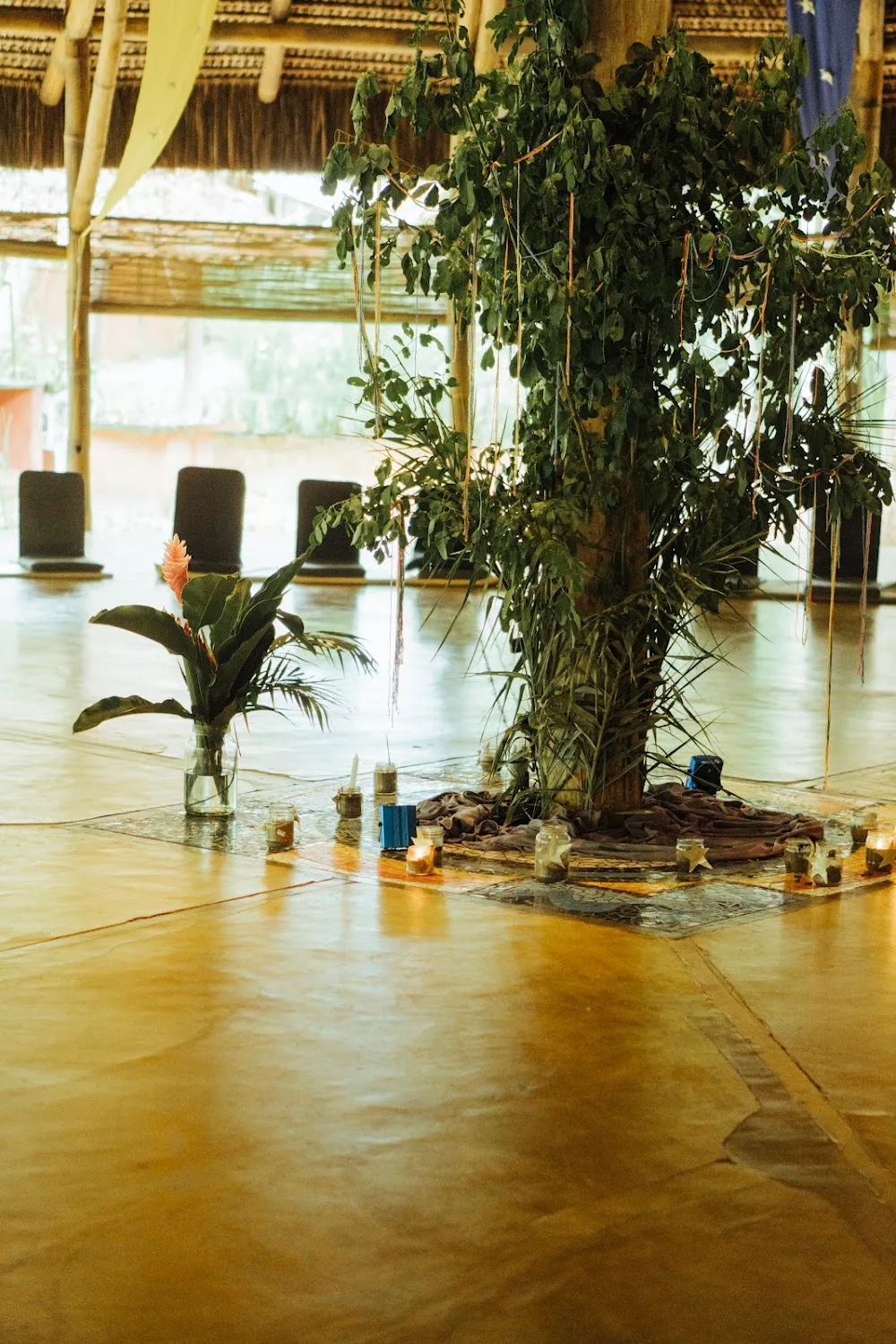 Shala set up for a retreat, with altar, candles, cushions and meditation chairs at Unah