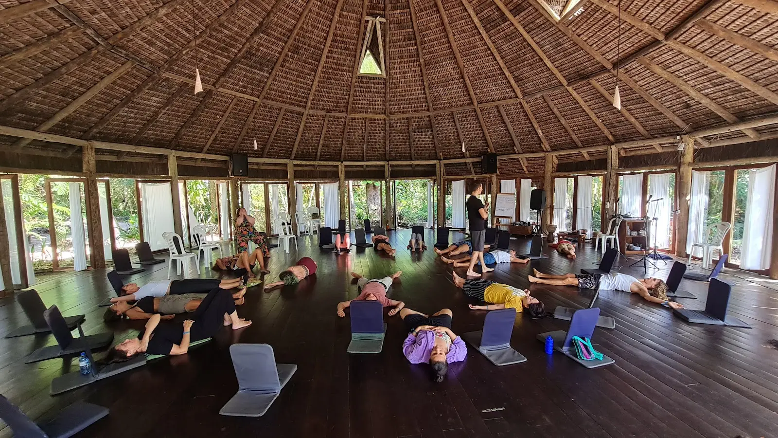 Retreat group practicing in a shala open to the Atlantic Forest at Unah, Bahia